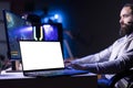 Isolated screen laptop next to man play spaceship flying game