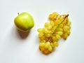 Isolated set of a green apple with a bunch of sweet seedless grapes in studio with white background