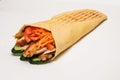 Isolated shawarma with a shadow. Oriental food made from chicken meat, tomatoes, cucumbers in pita bread