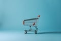 Isolated shopping trolley against calming blue background, minimalist vibe