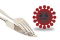 Isolated shot of an angry virus next to a fork and knife on white background