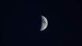 Isolated shot of the moon in its half phase on a dark starless night sky Royalty Free Stock Photo