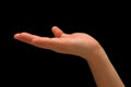 Isolated shot of outstretched hand signaling "in support of something" on a black background