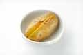 Isolated shot of sliced baked potato in a white bowl - perfcet for a recipe article