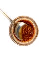 Isolated shot of a spoon scooping out bavarian mustard from a glass jar on a white background Royalty Free Stock Photo