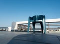 An Isolated shot of a vacant blue chair on the roof of an Indian household with blue sky in the background Royalty Free Stock Photo