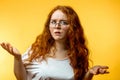 Isolated shot of young funny redhead female stares at camera with shoked expression