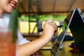 Isolated side view of freelancer woman hand pointing with stylus on convertible laptop screen in tent mode. Girl using 2 Royalty Free Stock Photo