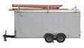 Isolated side view of older white utility work trailer
