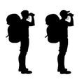 Isolated silhouette of a hiker looking through binoculars