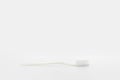 Isolated simple normal white toothbrush is laid on the white background in studio light. Clipping Path Royalty Free Stock Photo