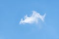 Isolated single white cloud against light blue sky with copy space Royalty Free Stock Photo