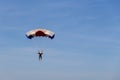 Isolated skydiver in colorful parachute gliding after free fall Royalty Free Stock Photo