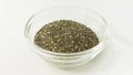 Isolated small glass bawl with raw chia seeds