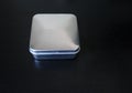 Isolated Plain rectangular tin cannister on a dark background holding unknown contents version 1