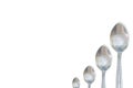 Isolated steel teaspoon order by size small to big on white background