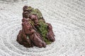 Isolated Stone in a Japanese Zen Garden with White Sand and Moss Royalty Free Stock Photo