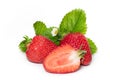 Isolated strawberries. Three fruits, one cut in half on white background Royalty Free Stock Photo