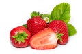 Isolated strawberries. Three fruits, one cut in half on white background Royalty Free Stock Photo