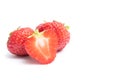 Isolated strawberries. Two whole strawberry fruits and half isolated on white background, with clipping path, copy space Royalty Free Stock Photo