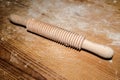 Isolated streaked wood rolling pin on wood table,homemade kitchen items