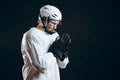 Caucasian hockey player, in uniform, isolated on black, prays for good luck.