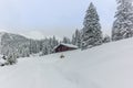 Isolated summer chalet and villages high up on the Swiss Alps covered in fresh powder snow near Davos Royalty Free Stock Photo