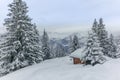 Isolated summer chalet and villages high up on the Swiss Alps covered in fresh powder snow near Davos Royalty Free Stock Photo