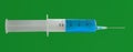 Isolated syringe with needle with blue liquid