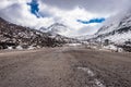 Isolated tarmac road with snow cap mountain background and amazing sky at morning Royalty Free Stock Photo