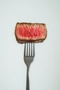 Isolated tender beef slice on a fork against a transparent background, a cutout stock image Royalty Free Stock Photo