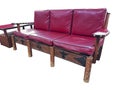 Isolated Thomas Molesworth furniture, western couch & table, has wood carving & red leather.