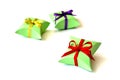 Isolated three apple-green paper gift boxes for jewelry with red, violet, golden satin ribbons bows on white background Royalty Free Stock Photo