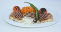 Grilled steak plate with roasted peppers, bulgur pilaf with tomatoes, roasted tomatoes