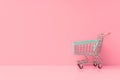 Isolated toy grocery cart on pastel pink background, copy space Royalty Free Stock Photo
