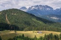 Isolated traditional house in a meadow in the middle of the woods in Austrian Alps, loneliness and quarantine concept Royalty Free Stock Photo