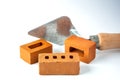 Isolated trowel and brick blocks on white background