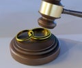 isolated two gold couple rings and gavel