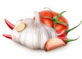 Isolated vegetables. Two garlic with segment, tomato, red hot chili peppers isolated on white background, with clipping path. Royalty Free Stock Photo