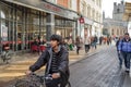 Isolated view of a Cambridge University Student seen cycling during a busy shopping time.