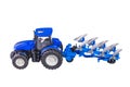 Isolated view of radio-controlled toy farm tractor model with plow on white background Royalty Free Stock Photo