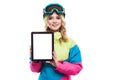 Young woman in ski suit show empty tablet Royalty Free Stock Photo