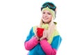 Pretty young woman in ski outfit and ski glasses hold red cup Royalty Free Stock Photo