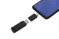 Isolated on a white background phone or smartphone with USB OTG data transfer connected to a USB flash drive Royalty Free Stock Photo