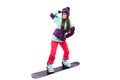 Pretty young woman in purple ski suit rides black snowboard Royalty Free Stock Photo