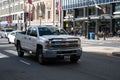 Isolated white Chevrolet car at a busy city intersection