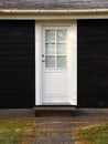 Isolated White Door on Black Wooden House Royalty Free Stock Photo