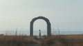 Isolated White Figure In Muted Seascape Archway: A Japanese Minimalism Artwork