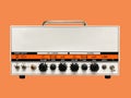 Isolated white iron modern drive medium electric guitar amplifier head on orange background with copy space. Royalty Free Stock Photo