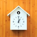 Isolated white object, Vintage wall clock with birdhouse style on gold wooden pattern wall background